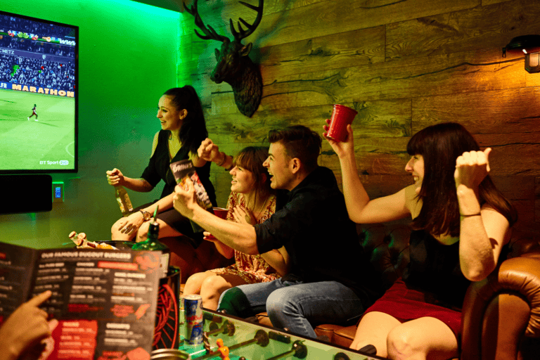 A group of people celebrating in a Belushi's Bar.